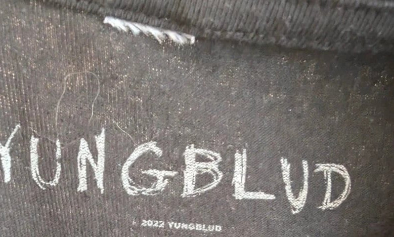 Yungblud black graphic tee with metallic silver portrait and neon pink tour lettering.
