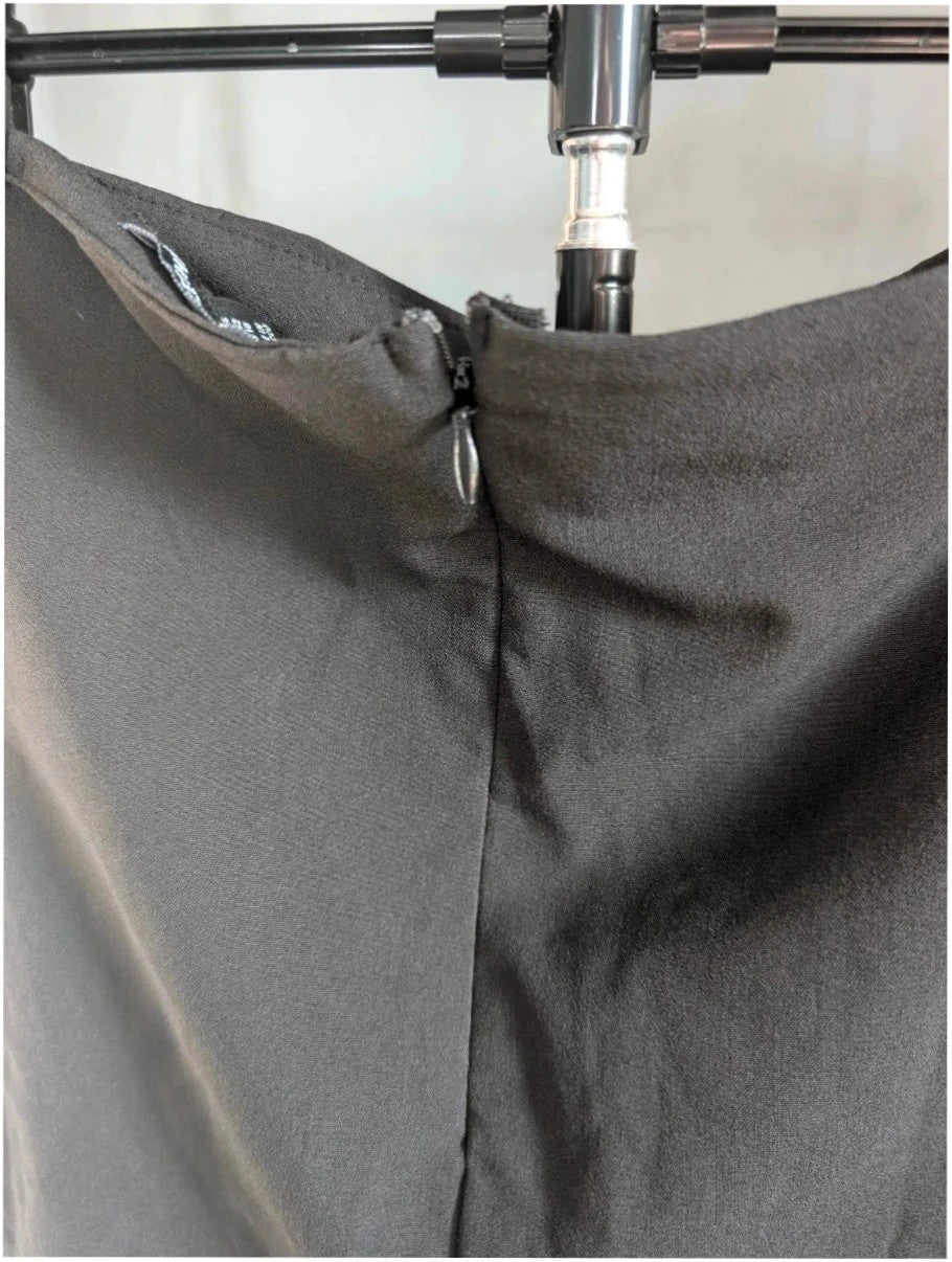 PrettyLittleThing black mini skirt with white satin bow detail and high-waisted fit.