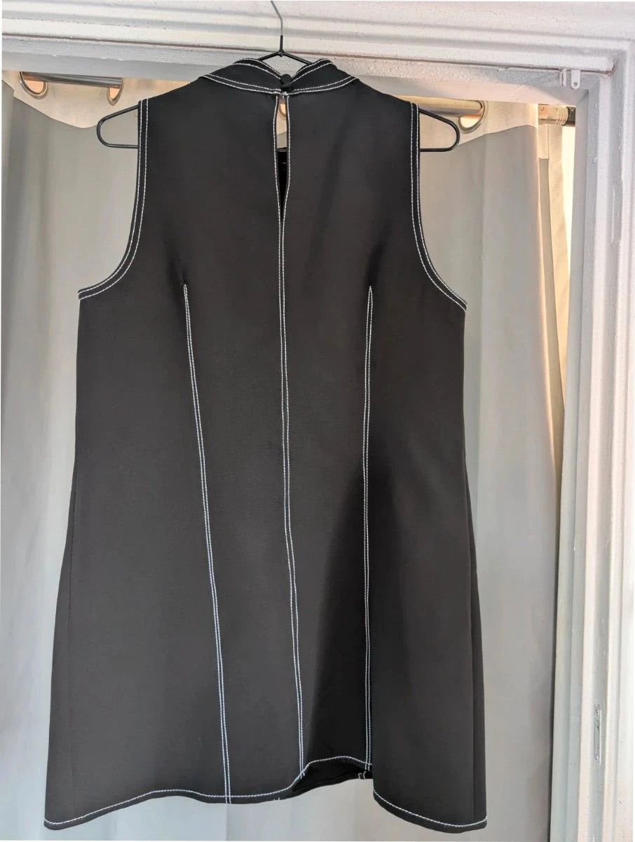 River Island black sleeveless mini dress with white contrast stitching and mock neck collar.