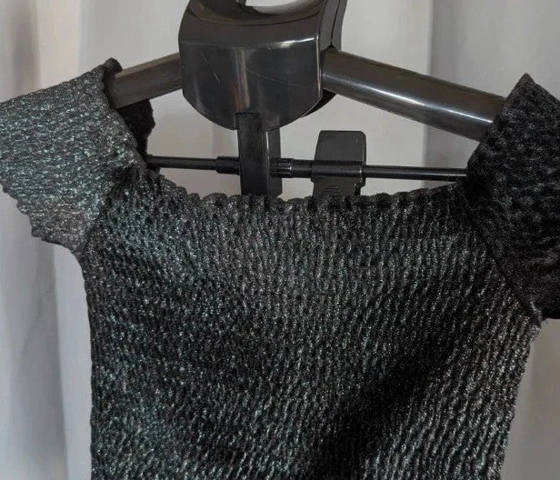 Light Before Dark black and silver smocked crop top with metallic shimmer and ruffle trims.