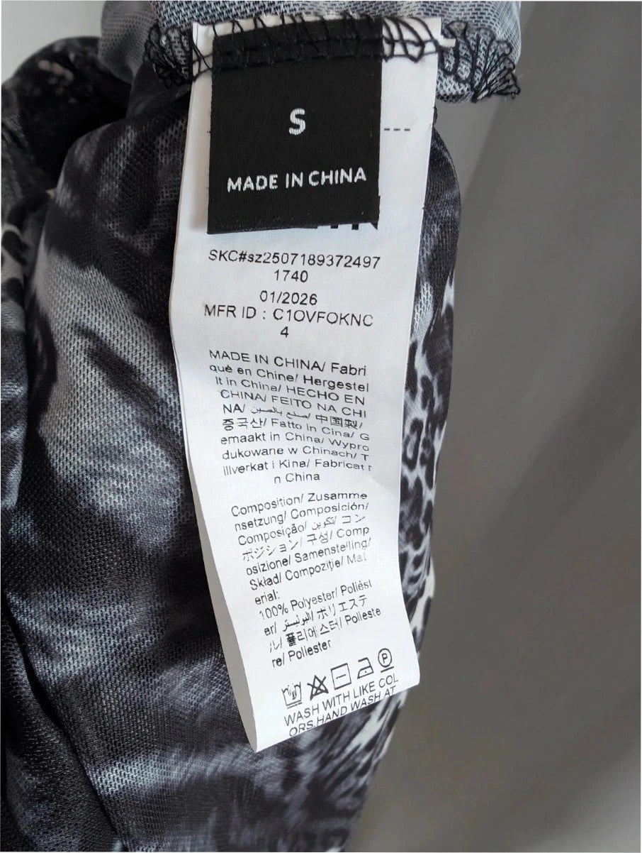 SHEIN grey animal print sheer mesh jumpsuit with high neckline and keyhole cutout.