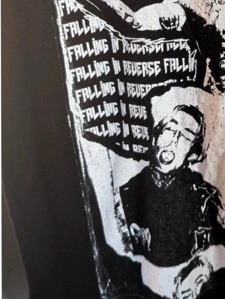 Next Level black graphic tee featuring pink Falling In Reverse logo and band portrait.