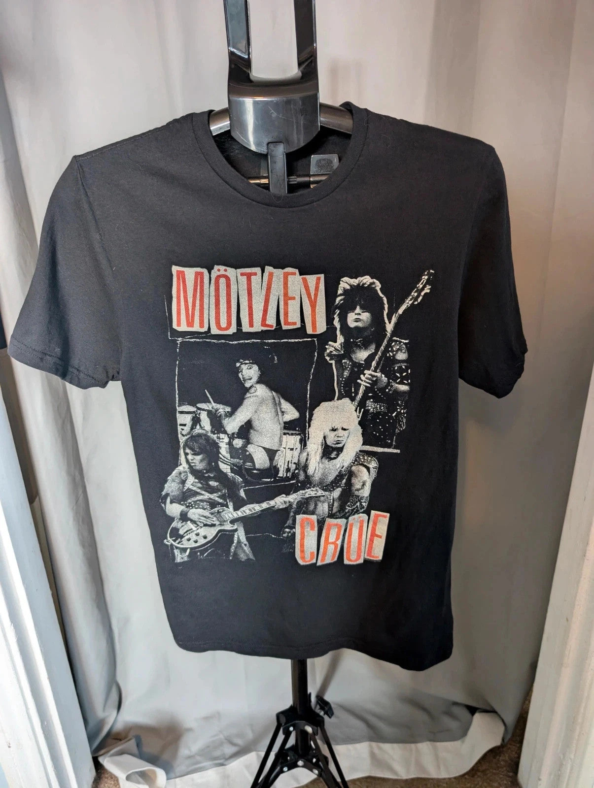 Mötley Crüe black graphic tee featuring retro band collage and red logo lettering.