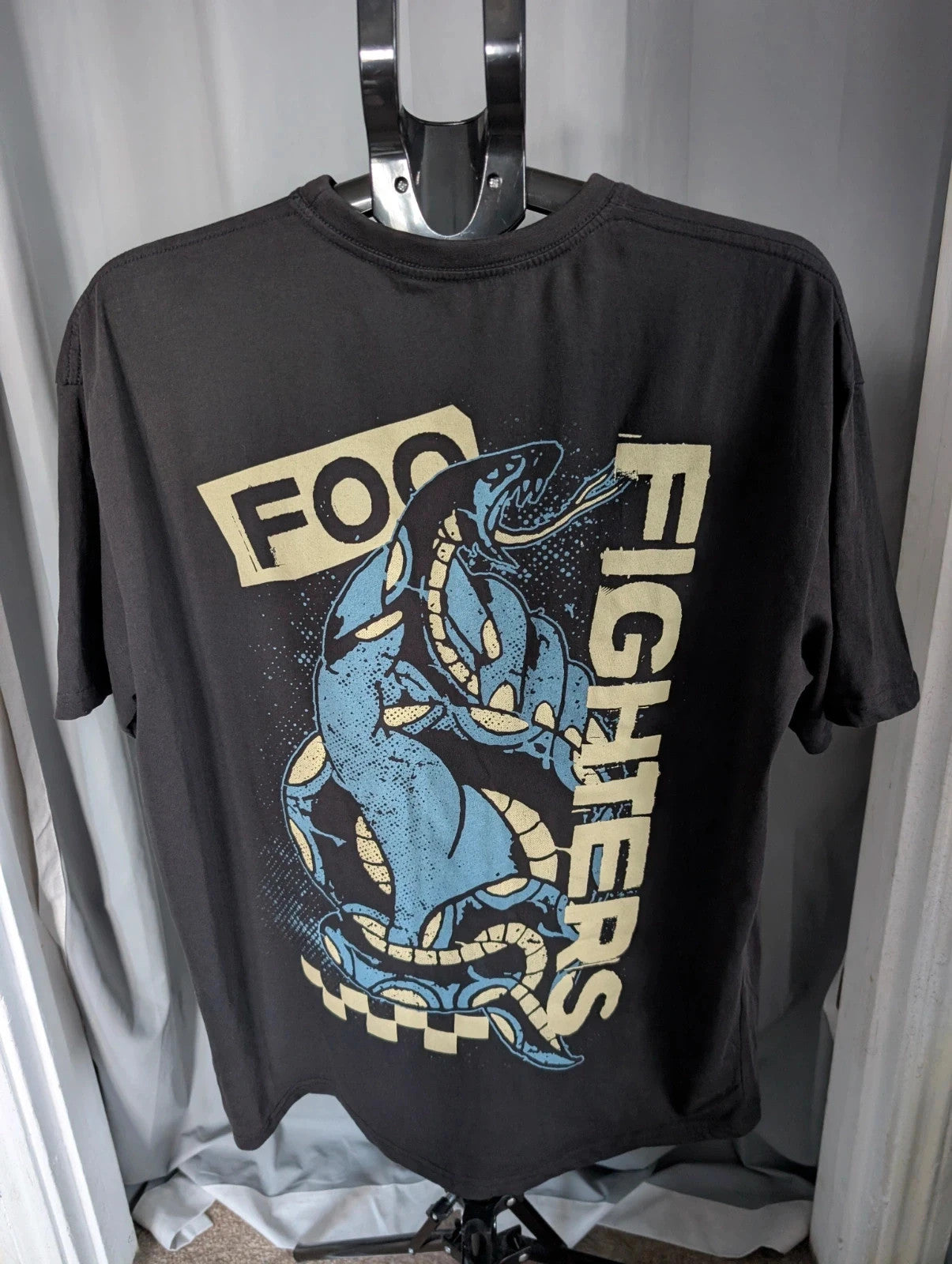 Foo Fighters black graphic tee with coiling snake and checkerboard pattern, soft cotton.
