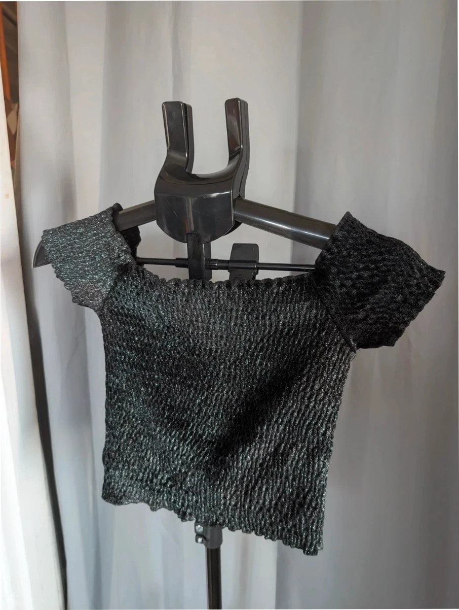 Light Before Dark black and silver smocked crop top with metallic shimmer and ruffle trims.