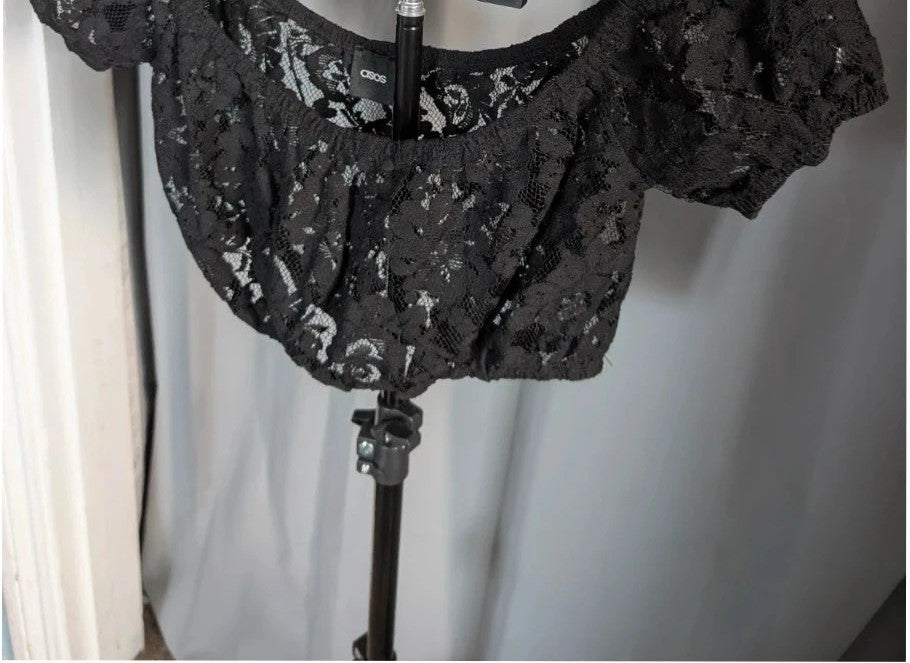 ASOS black sheer floral lace crop top with off-the-shoulder Bardot neckline and puff sleeves.