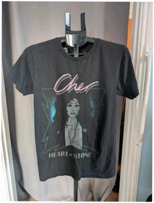 Bravado black graphic t-shirt featuring Cher portrait print with pink and blue accents.