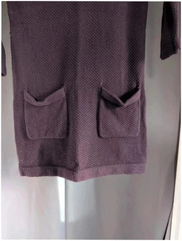 Purple knit sweater dress with long sleeves, relaxed fit, and functional front pockets.
