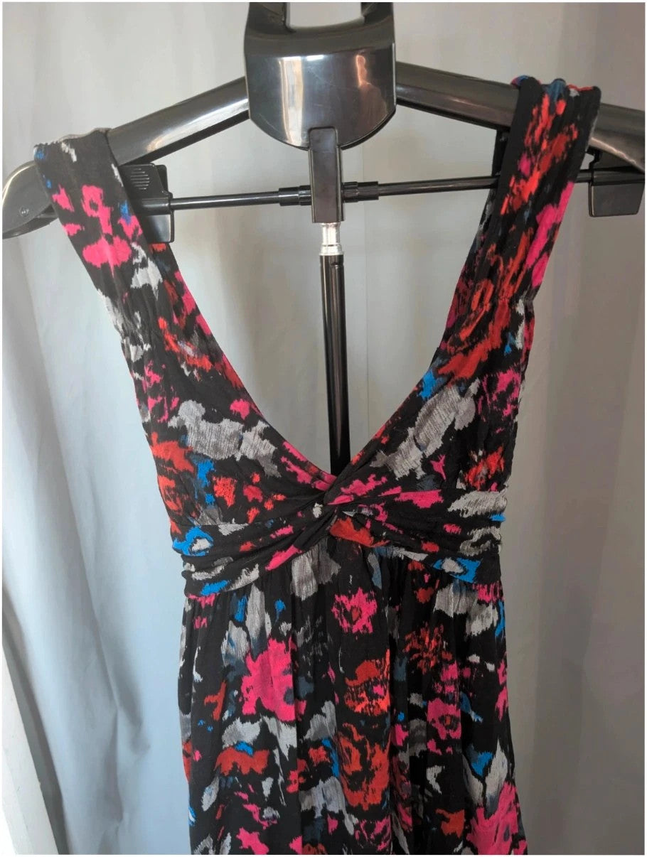 Rise black linen maxi dress with vibrant pink floral print and twist front V-neck.