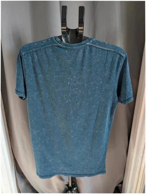 Billie Eilish blue acid wash pocket t-shirt with multicolour graphic and red text.