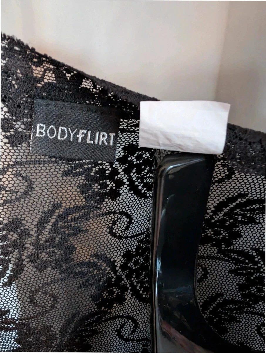 Bodyflirt black skater dress with floral lace yoke, deep V-neckline, and pleated skirt.