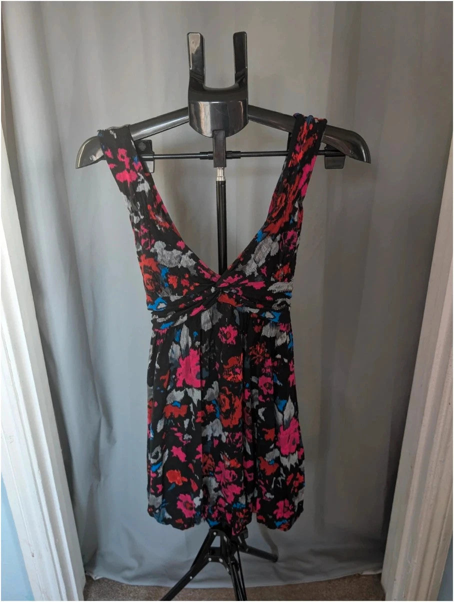 Rise black linen maxi dress with vibrant pink floral print and twist front V-neck.