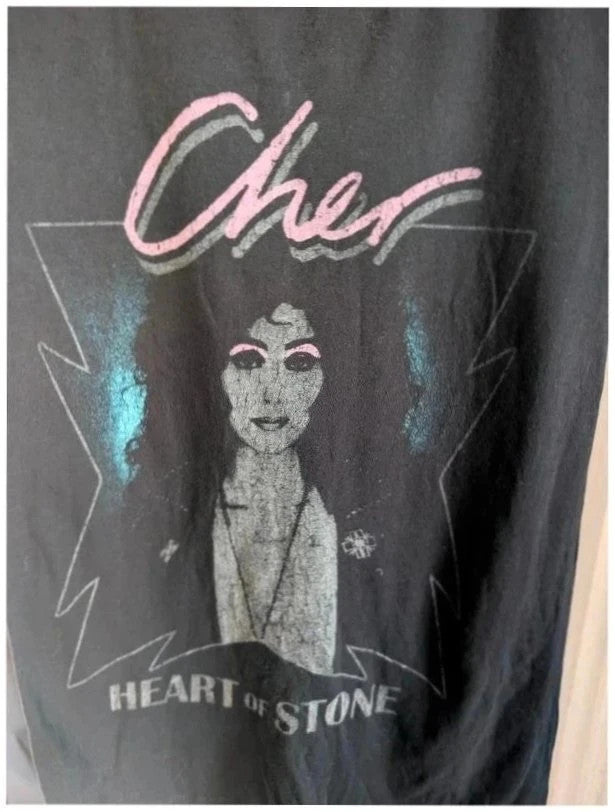 Bravado black graphic t-shirt featuring Cher portrait print with pink and blue accents.