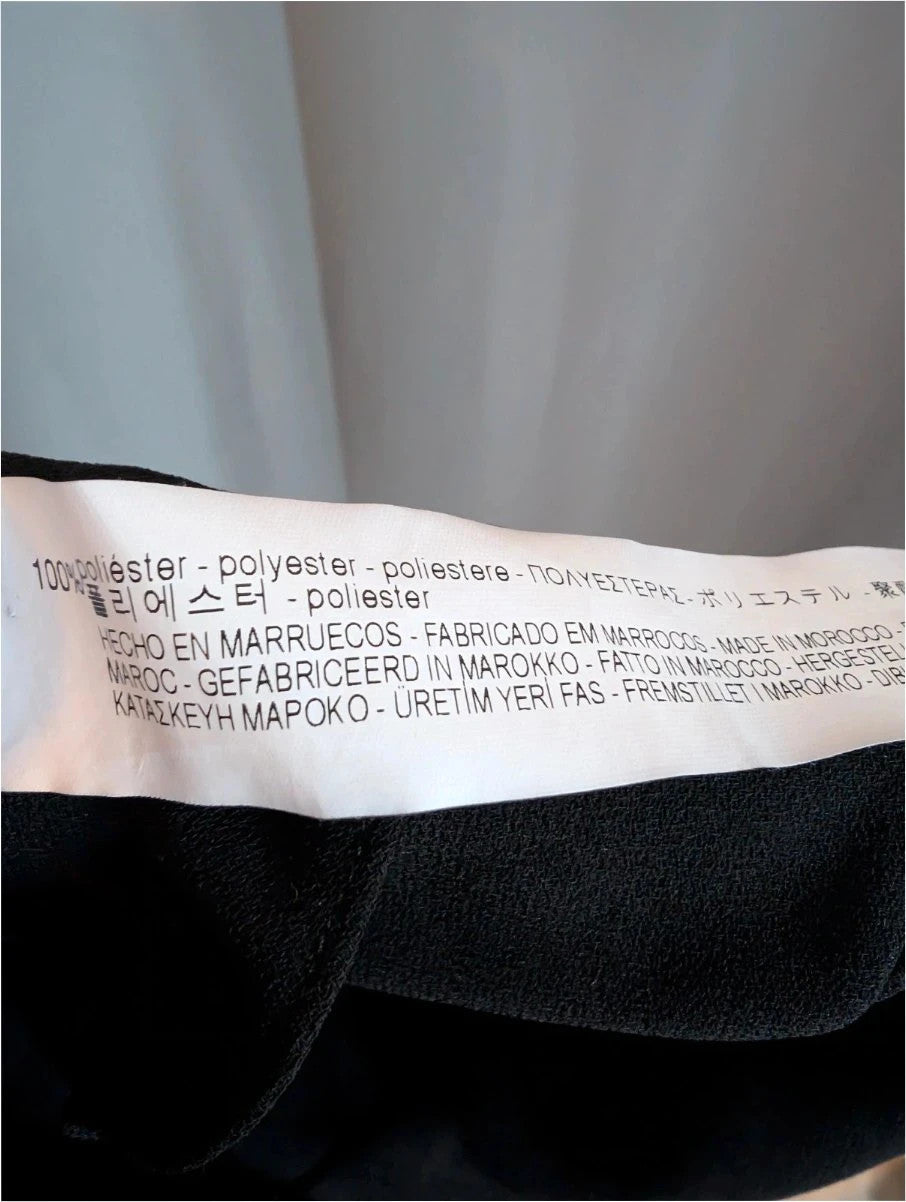 Zara Woman black pencil dress with high frill neckline and vertical ruffle trim.