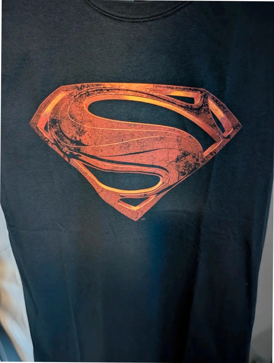Superman black graphic tee with distressed metallic orange shield logo on soft cotton.