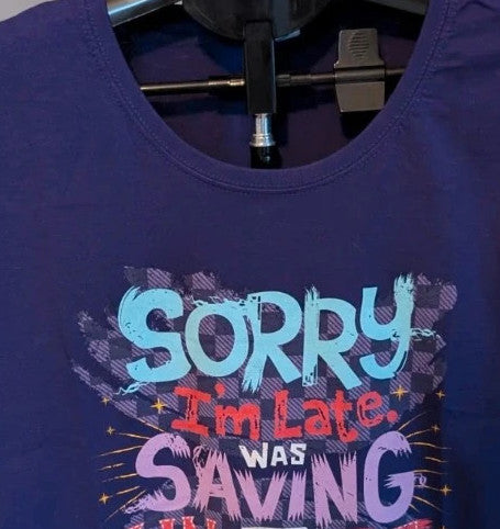 Marvel graphic t-shirt purple featuring "Sorry I'm Late" text and Captain Marvel star motif.