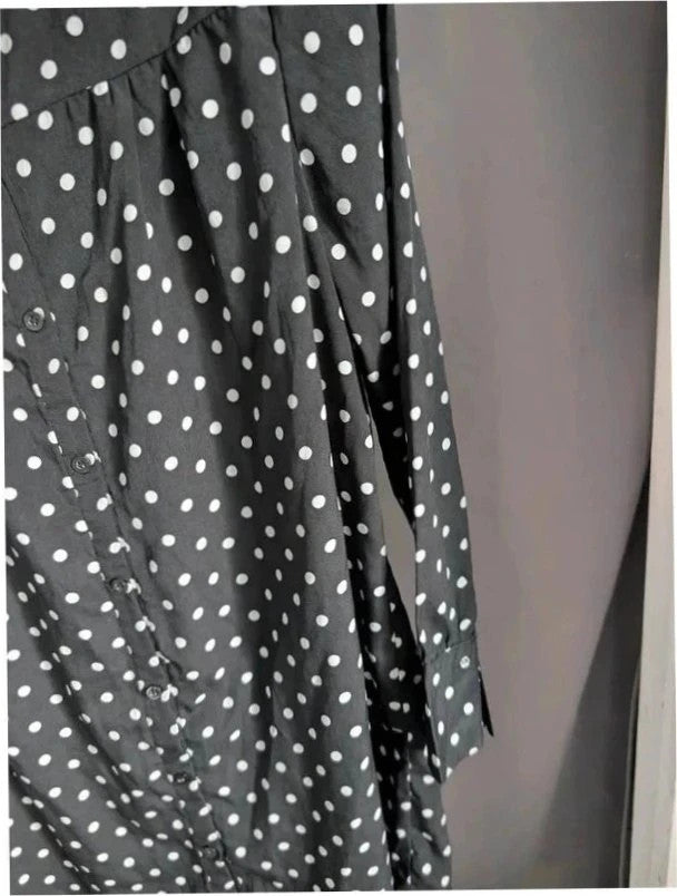Voyelles black and white polka dot blouse with ruffle collar and button-up front.