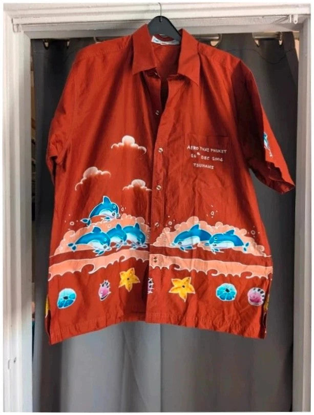 Phuket Batik burgundy graphic tee hand-painted dolphins and embroidered chest pocket detail.