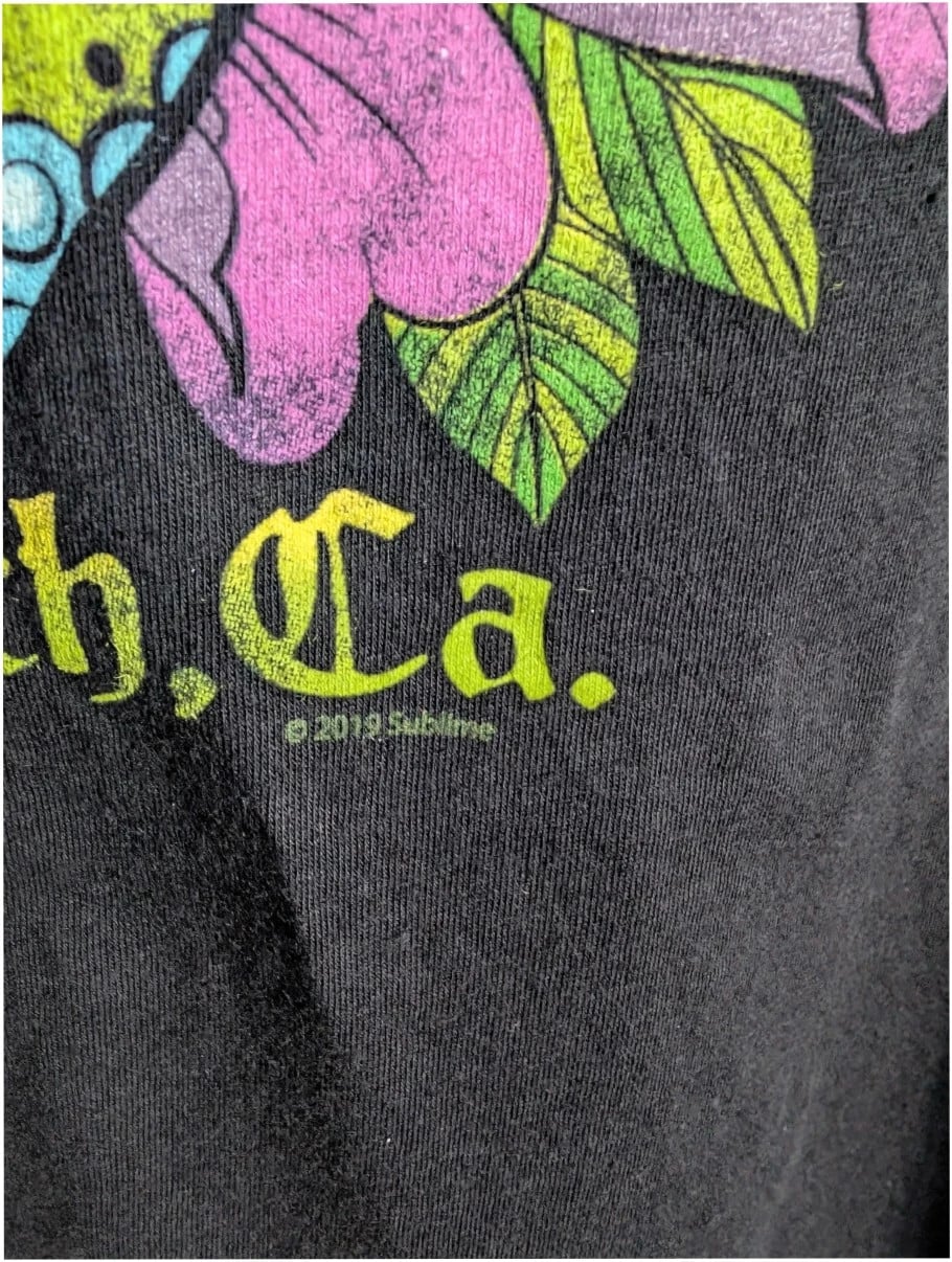 Sublime graphic tee black featuring vibrant sugar skull print with roses and gothic lettering.