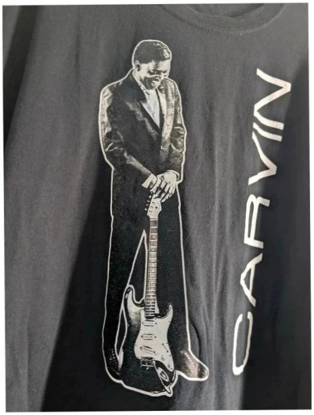 Official Carvin Jones black graphic tee featuring bold guitar artwork and tour dates print.