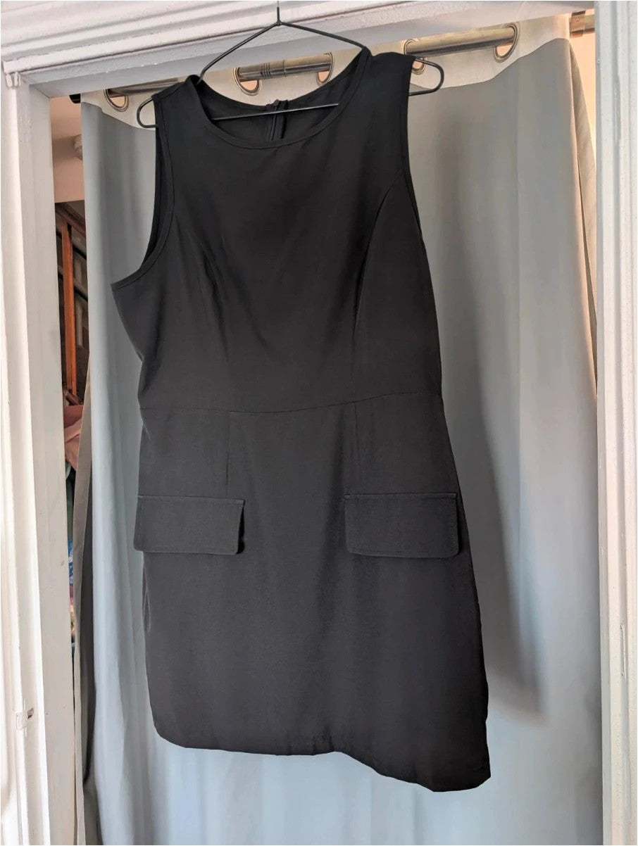 SHEIN black sleeveless mini dress with front flap pockets and back zip fastening.