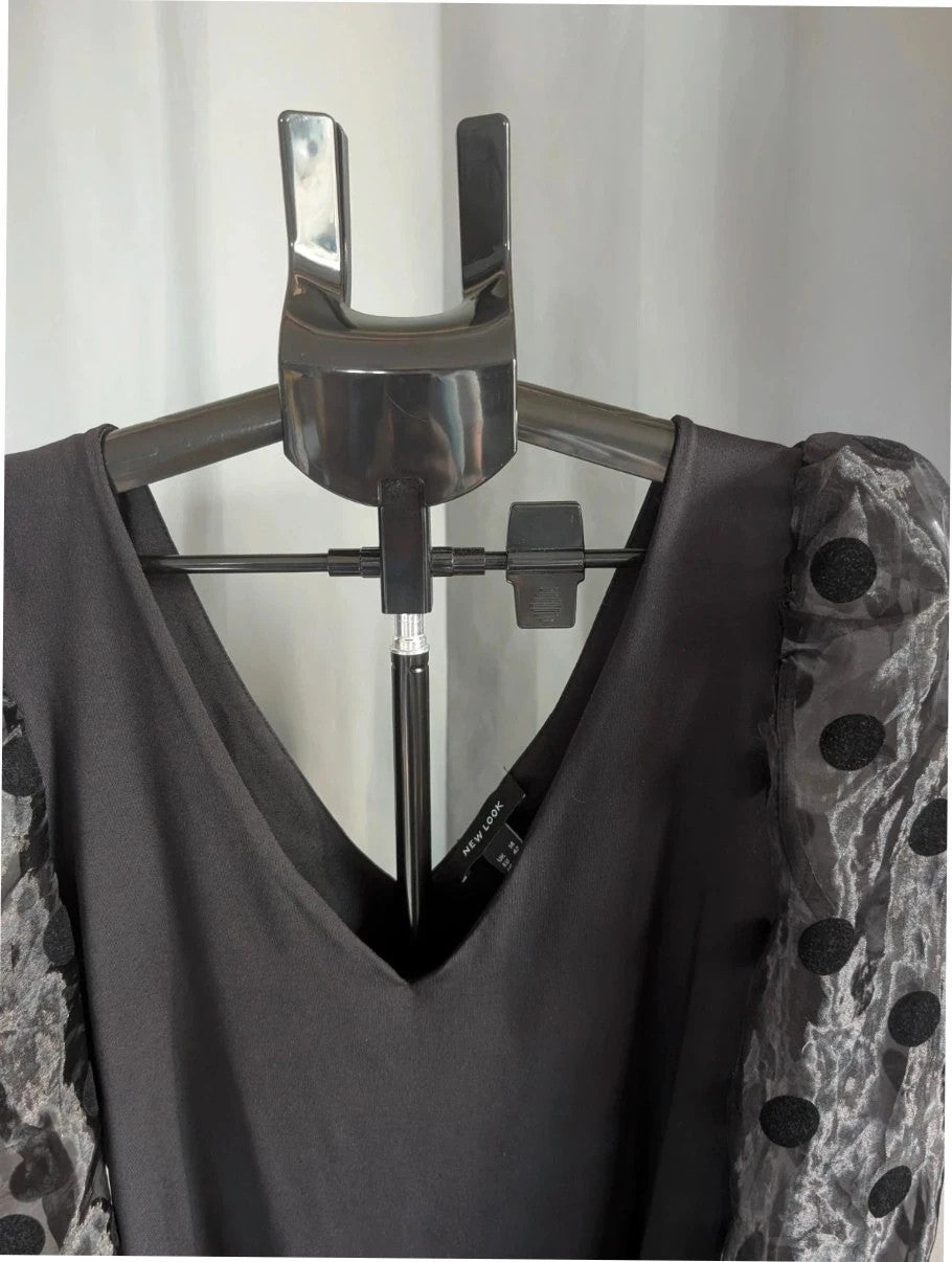 New Look black bodysuit with mesh polka dot sleeves and plunge V-neckline.