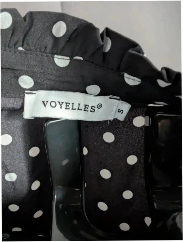 Voyelles black and white polka dot blouse with ruffle collar and button-up front.