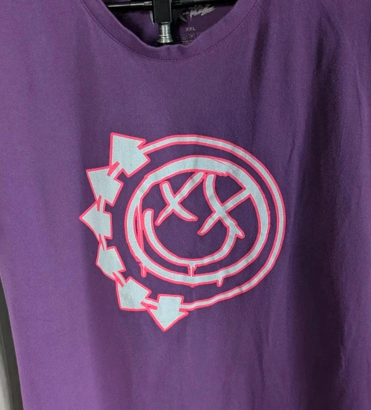 Blink-182 purple graphic tee featuring smiley face logo with neon pink outlining and drip detailing.