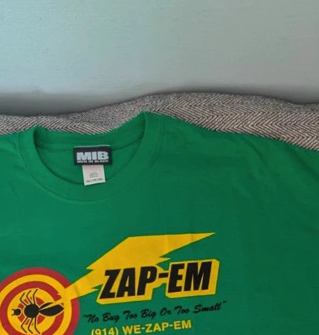 Gildan green graphic tee featuring Men In Black "Zap-Em Exterminators" logo and slogan.