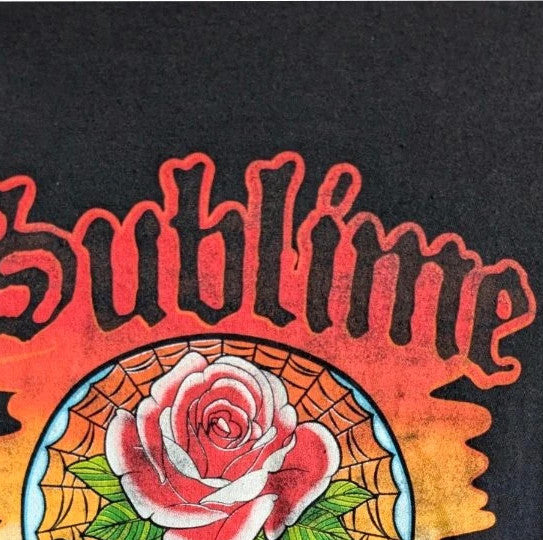 Sublime black graphic tee featuring vibrant sugar skull print, red rose, and gothic lettering.