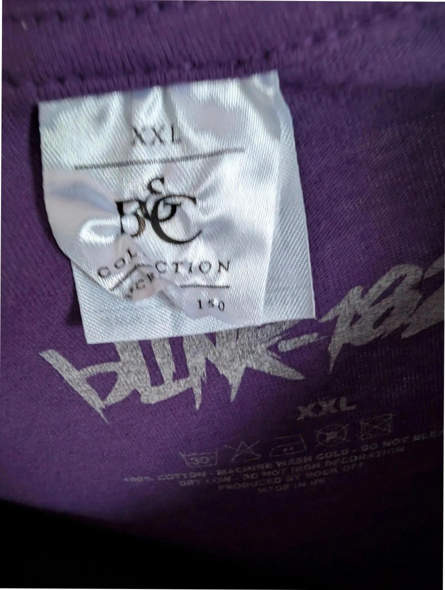 Blink-182 purple graphic t-shirt featuring smiley face logo with neon pink drip detailing.