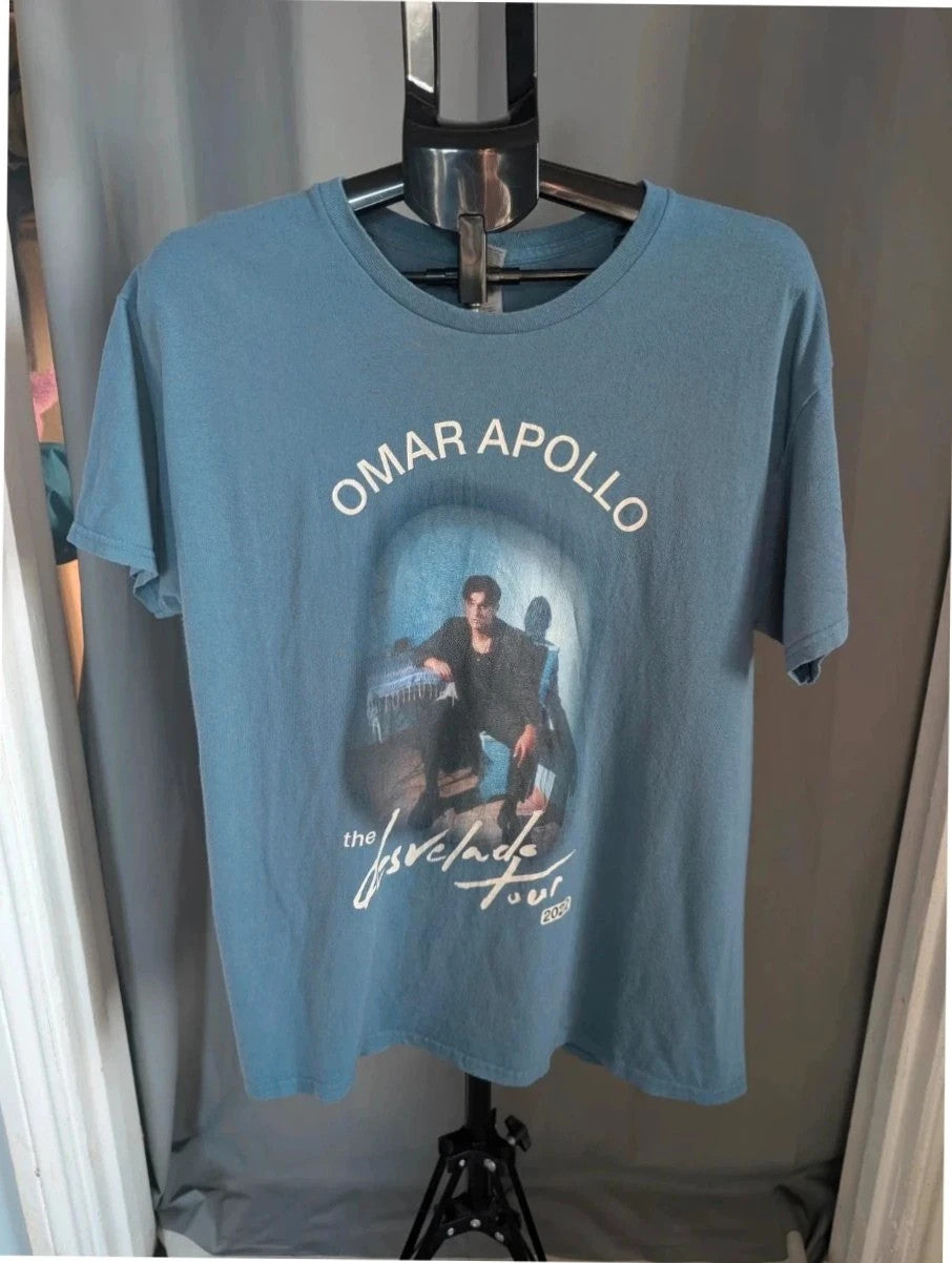 Omar Apollo blue graphic t-shirt with portrait print and tour date list on back.