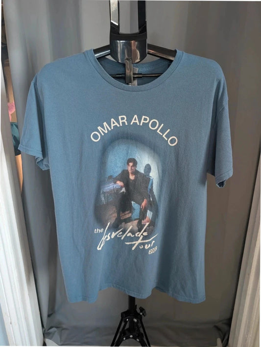 Omar Apollo blue graphic tee featuring portrait print and tour date list on back.