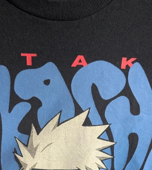 Naruto black graphic t-shirt featuring Kakashi Hatake, bubble typography, and Sharingan eye design.