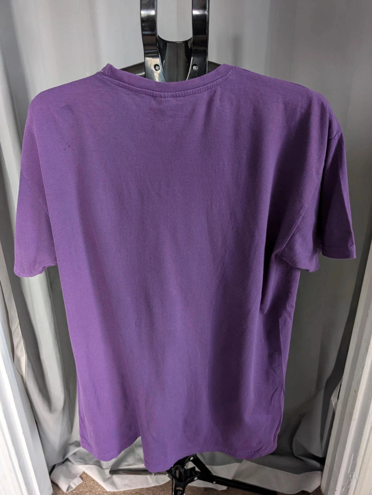 Blink-182 purple graphic tee featuring smiley face logo with neon pink outlining and drip detailing.