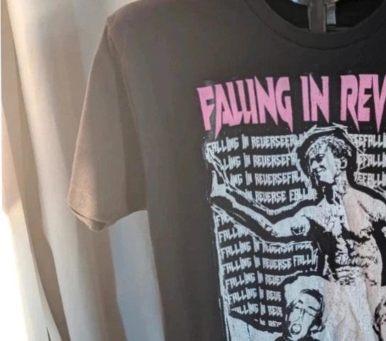 Next Level black graphic tee featuring Falling In Reverse pink logo and band portrait.
