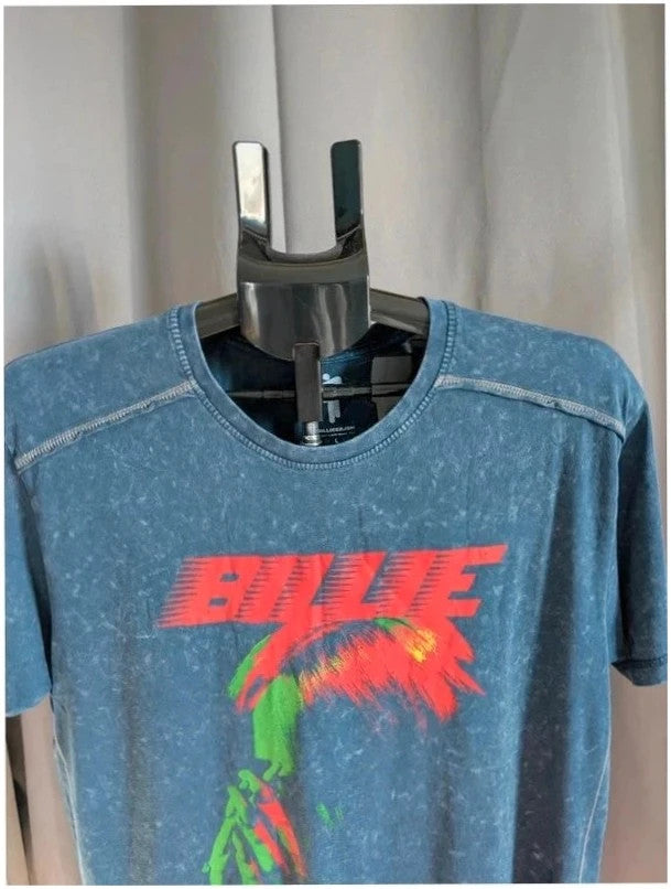 Billie Eilish blue acid wash pocket t-shirt with multicolour graphic and red text.