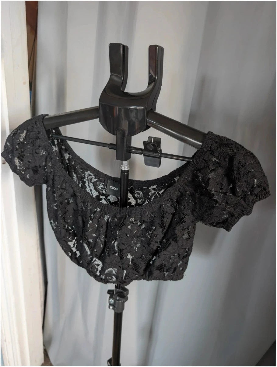 ASOS black sheer floral lace crop top with off-the-shoulder Bardot neckline and puff sleeves.