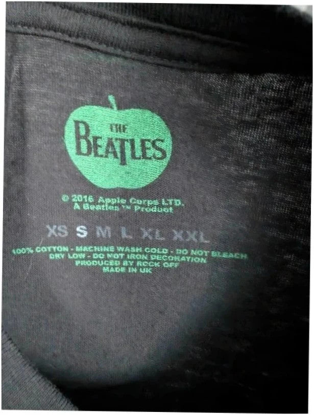 The Beatles black graphic tee featuring vibrant blue and white documentary print.