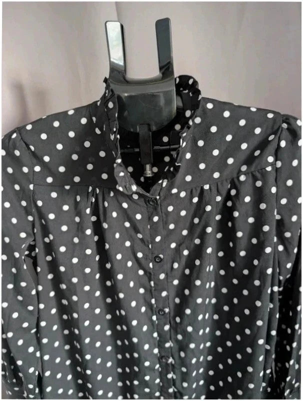 Voyelles black and white polka dot blouse with ruffle collar and button-up front.