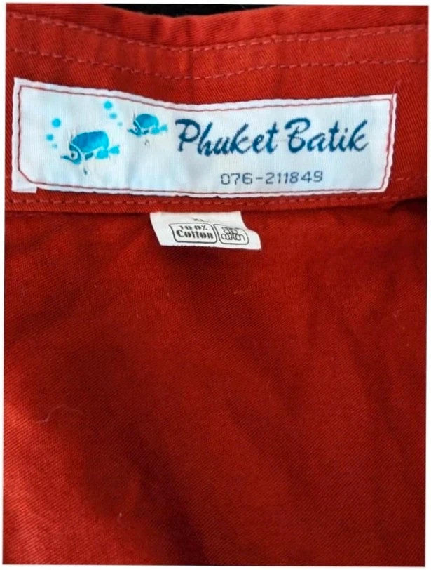Phuket Batik burgundy graphic tee hand-painted dolphins and embroidered chest pocket detail.
