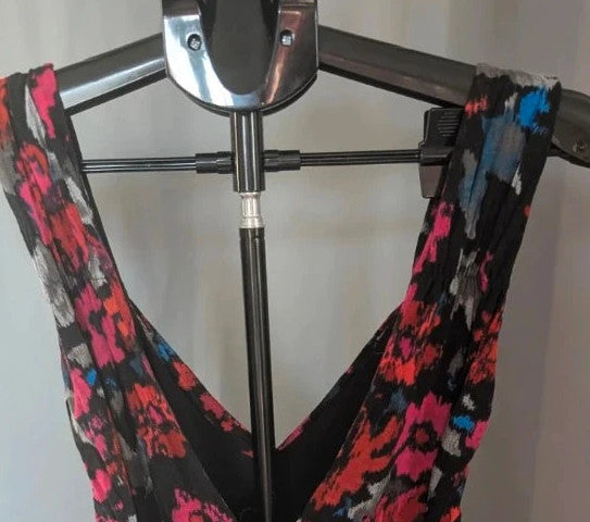 Rise black linen maxi dress with vibrant pink floral print and twist front V-neck.