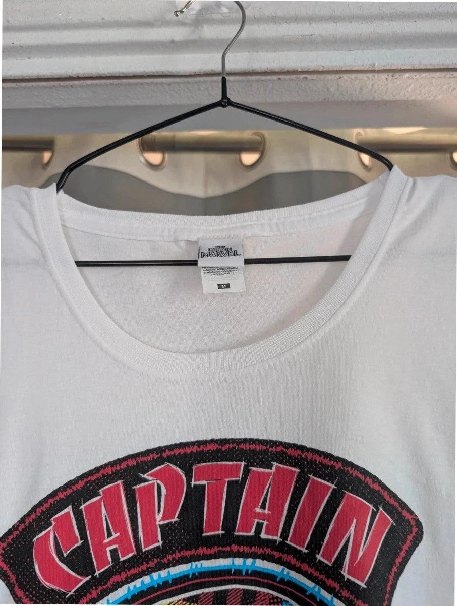 Marvel white graphic t-shirt featuring Captain Marvel print and retro patch-style lettering.