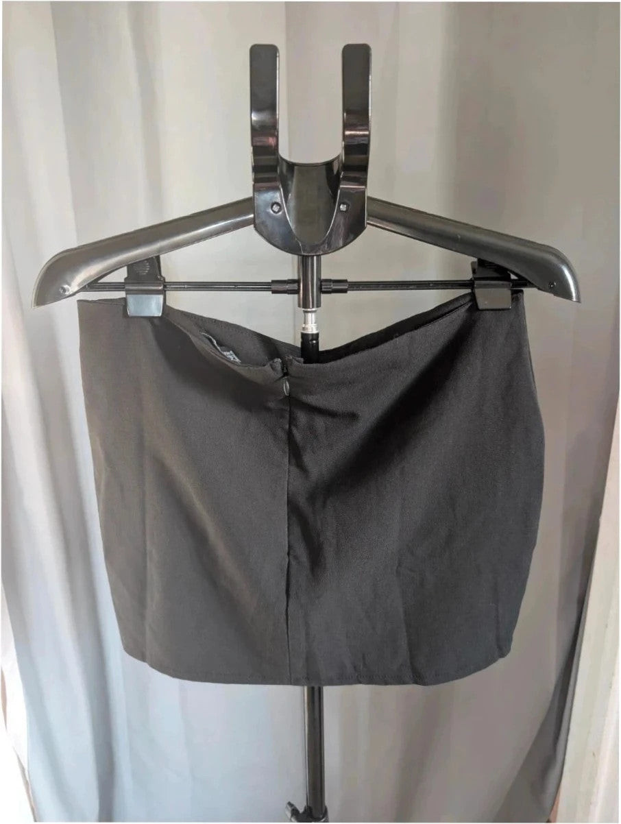 PrettyLittleThing black mini skirt with white satin bow detail and high-waisted fit.