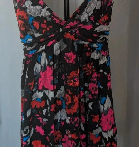 Rise black linen maxi dress with vibrant pink floral print and twist front V-neck.