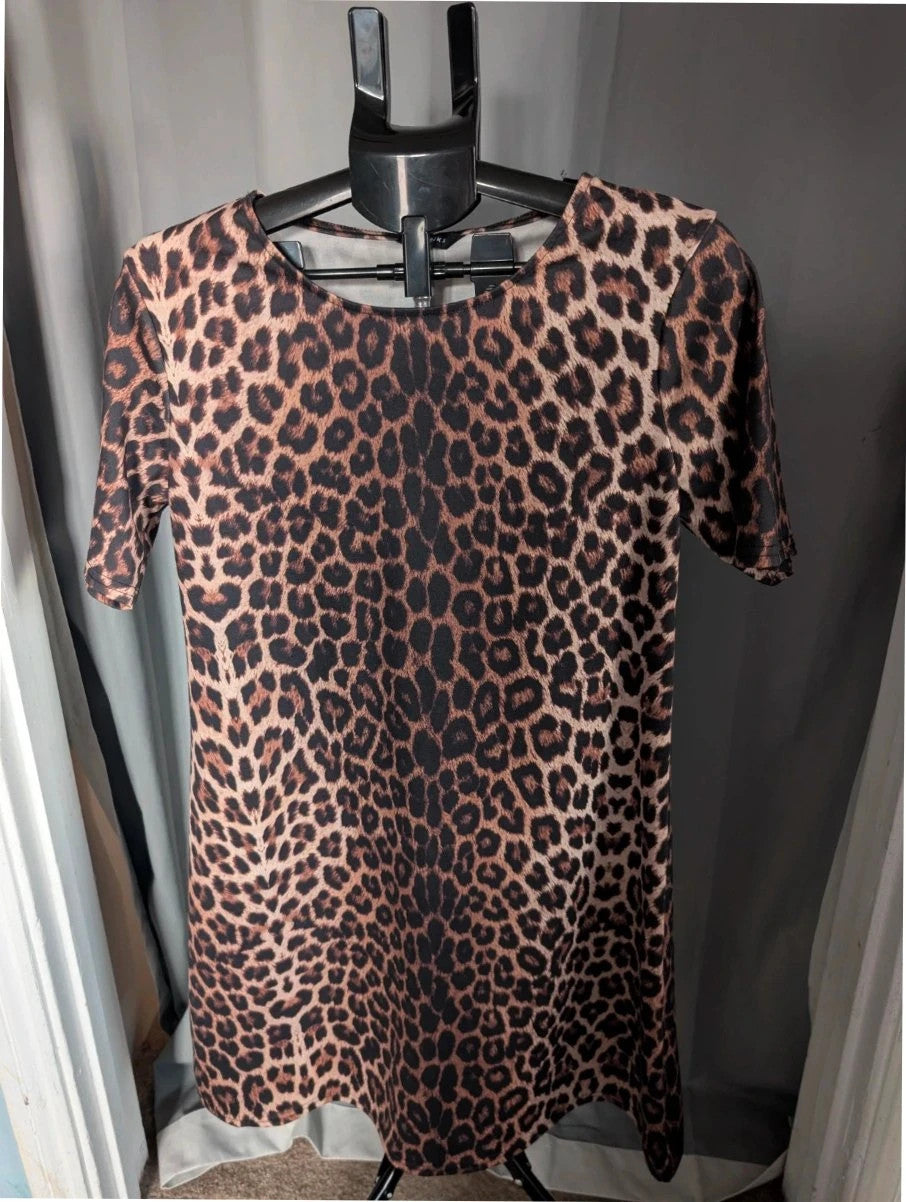 Peacocks leopard print shift mini dress in black and brown with scoop neckline and short sleeves.