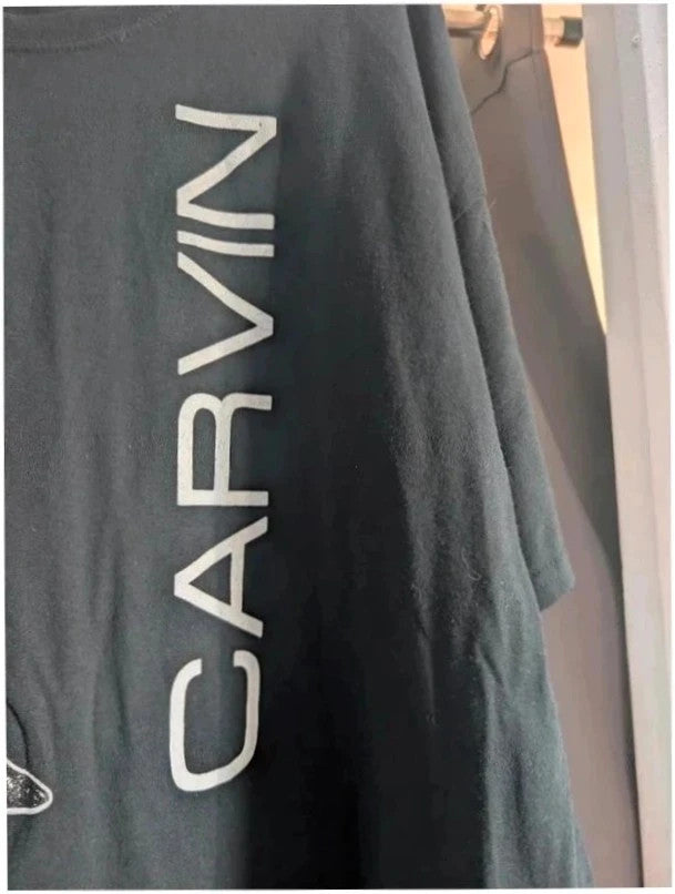Official Carvin Jones black graphic tee featuring bold guitar artwork and tour dates print.