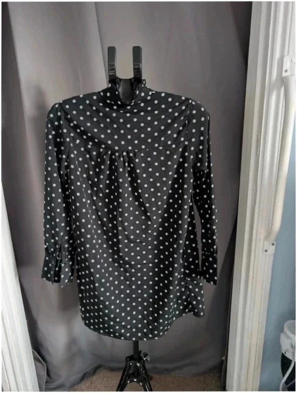 Voyelles black and white polka dot blouse with ruffle collar and button-up front.