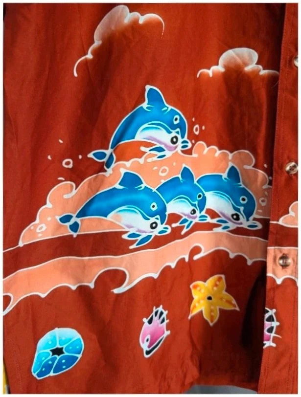 Phuket Batik burgundy graphic tee hand-painted dolphins and embroidered chest pocket detail.