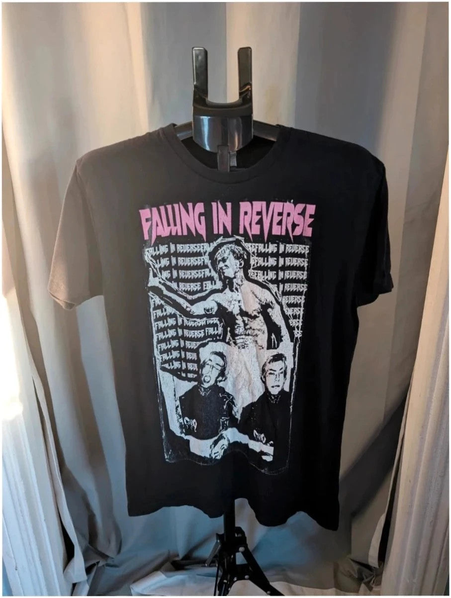 Next Level black graphic tee featuring Falling In Reverse pink logo and band portrait.